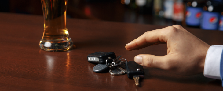 Man grabbing keys to drive after drinking