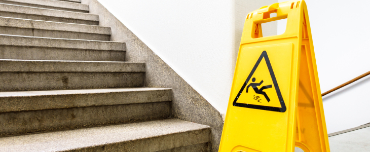 Caution wet floor sign in a stairwell to represent premises liability