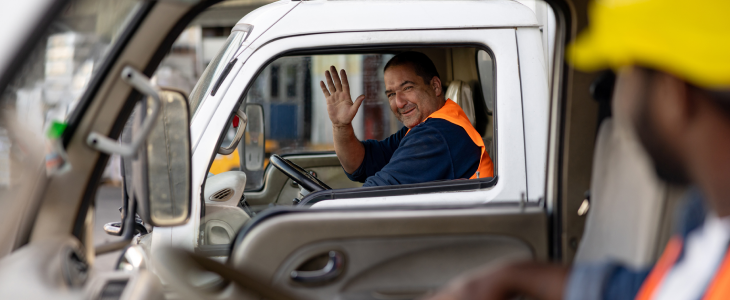 Truck driver waving hi to his coworker