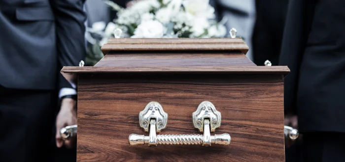 Family members carrying a casket