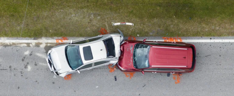 Car crash with two vehicles collided at traffic accident site on American street.